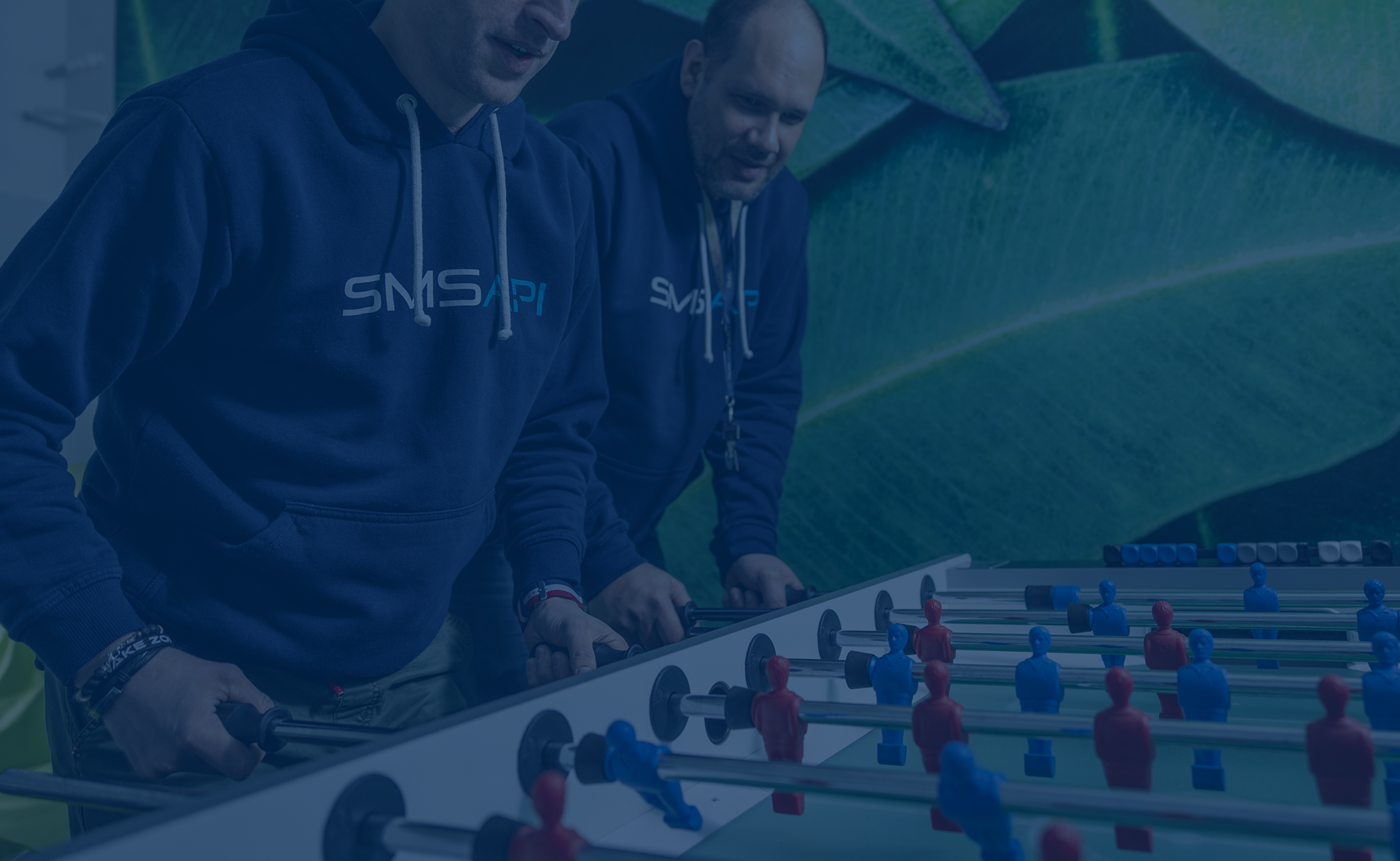 SMSAPI team playing table football